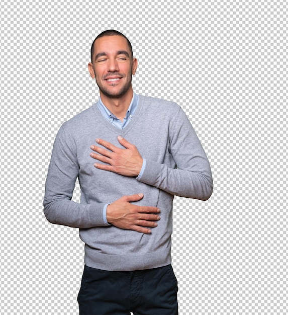 Happy young man laughing against background