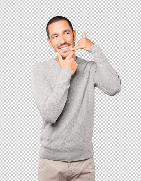 Happy young man making a gesture of calling with the hand