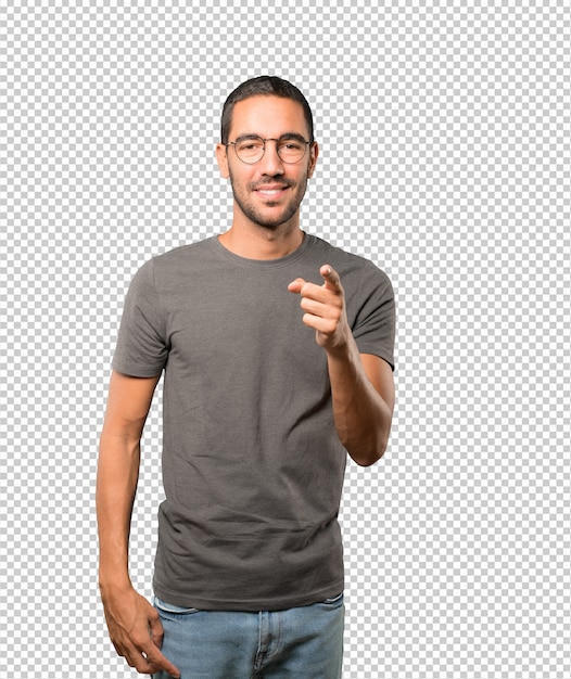 Happy young man pointing at you with his finger