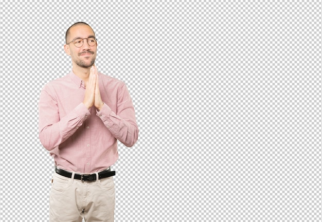 Happy young man praying gesture