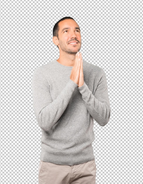 Happy young man praying gesture