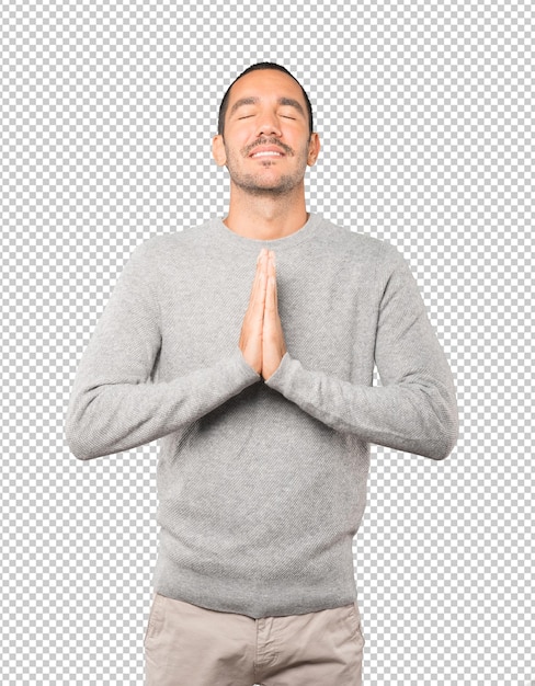 Happy young man praying gesture