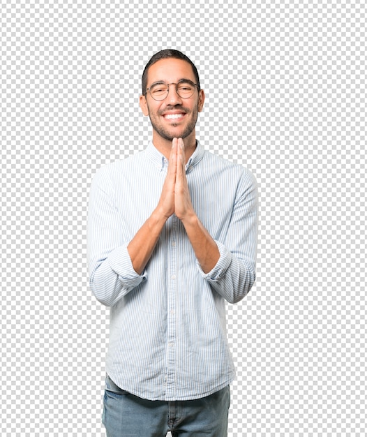 Happy young man praying gesture