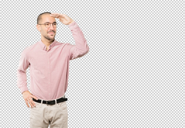 Happy young man with a gesture of looking away