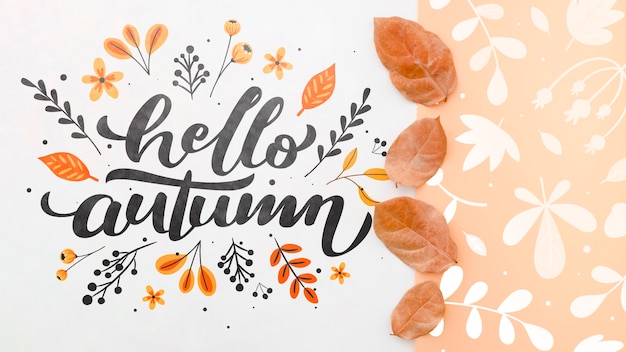 PSD hello autumn lettering next to brown leaves pattern