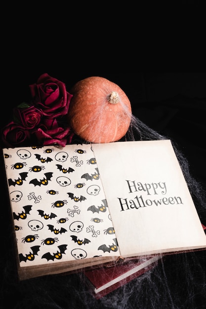 High angle of halloween concept with book and spiderweb