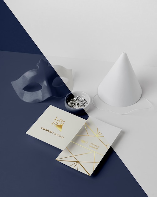 High angle of minimalistic carnival invitation with cone and mask