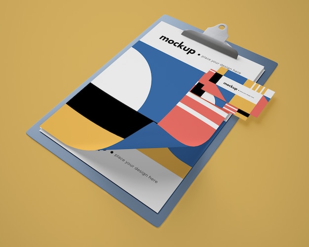 High angle of notepad mock-up with geometric design and card