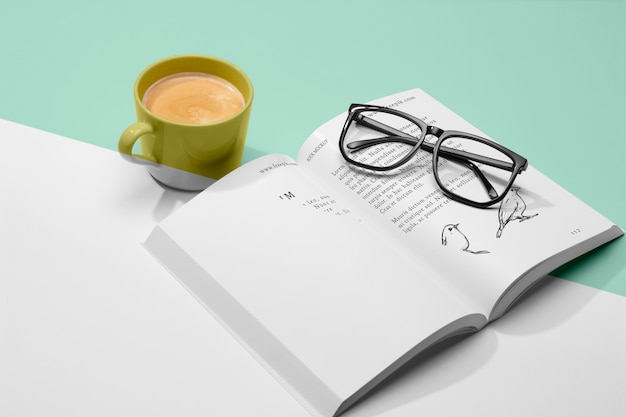 High angle open book mock-up with coffee and glasses