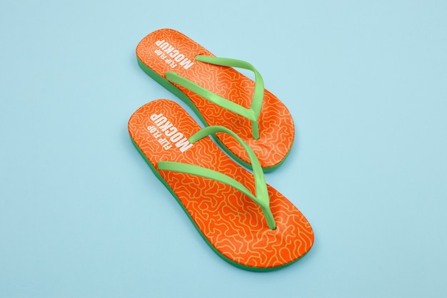 High angle orange flip flops in studio