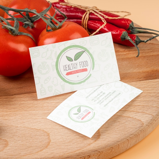 High angle of tomatoes and chili peppers on wooden surface