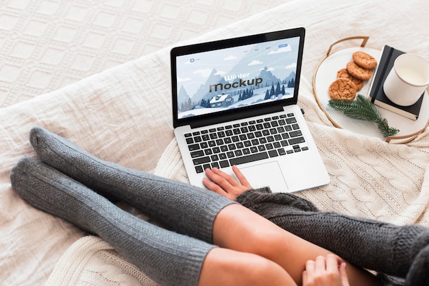 PSD high angle woman looking at a laptop with mock-up screen