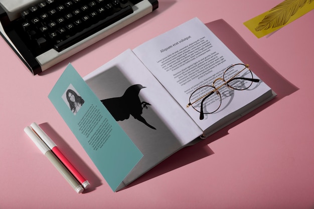 High view reading glasses on book and typewriter