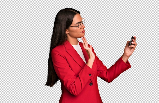 Hispanic pretty young adult and expressive businesswoman using a telephone