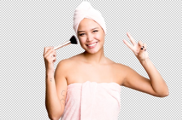 Hispanic pretty young woman wearing bathrobe beauty and make up concept