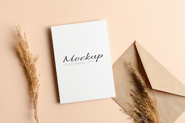 Invitation or greeting card mockup with envelope and dry grass decorations