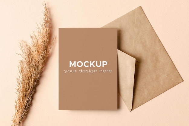 Invitation or greeting card mockup with envelope and dry plant decorations