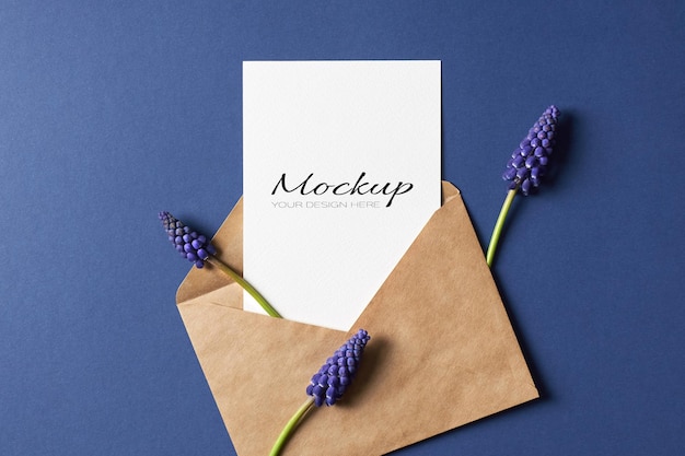 Invitation or greeting card mockup with envelope and spring blue muscari flowers