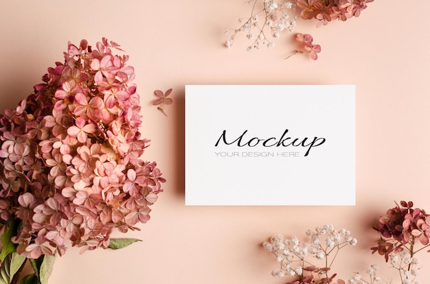 Invitation or greeting card mockup with pink gypsophila and hydrangea flowers