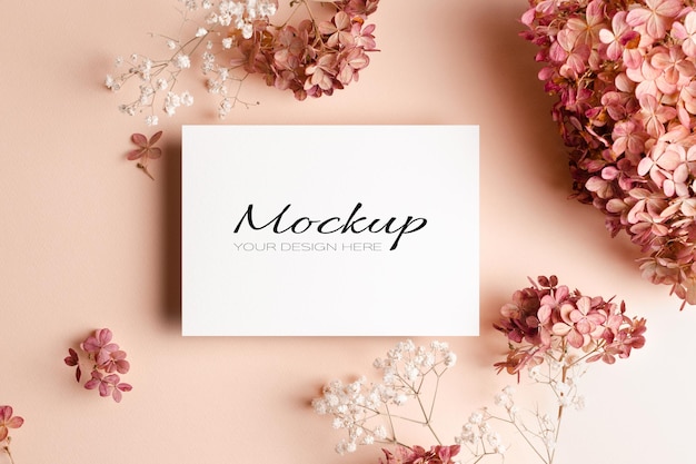 Invitation or greeting card mockup with pink gypsophila and hydrangea flowers