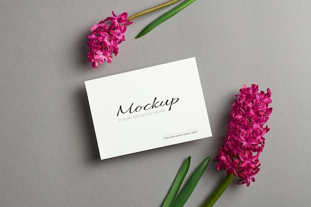 Invitation or greeting card mockup with spring hyacinth flowers on grey paper background