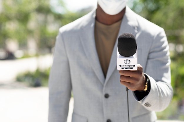 Journalist holding a microphone mockup