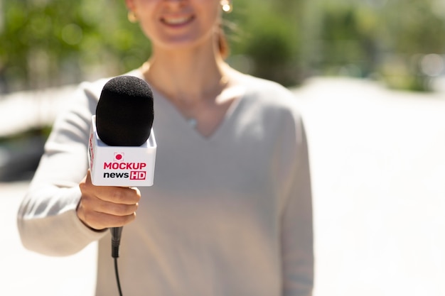 Journalist holding a microphone mockup