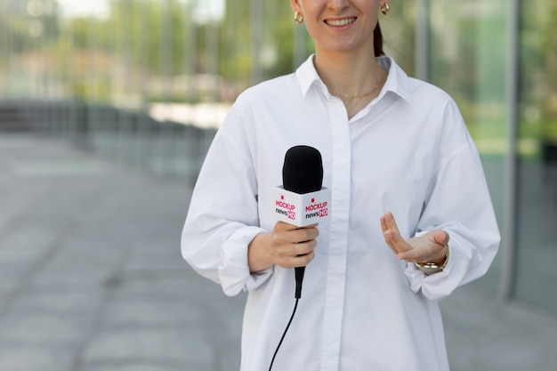 Journalist holding a microphone mockup