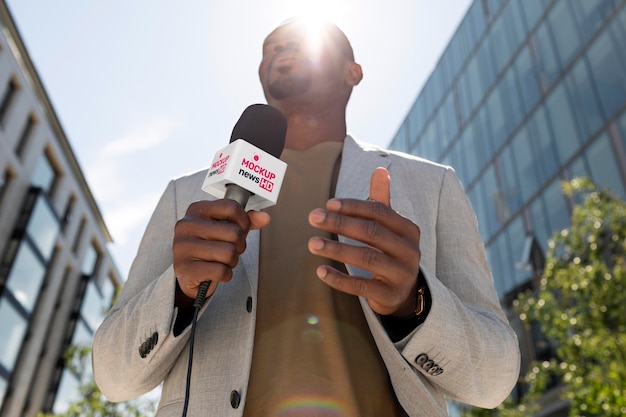 Journalist holding a microphone mockup