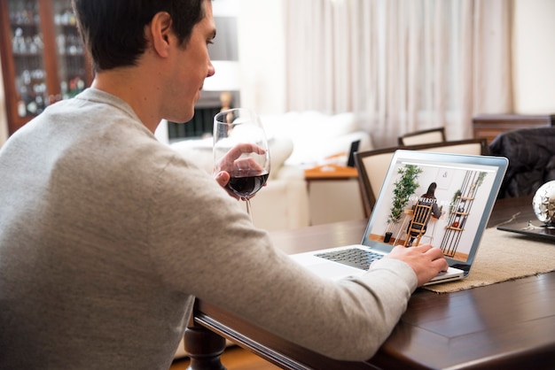 Laptop mockup with man working at home