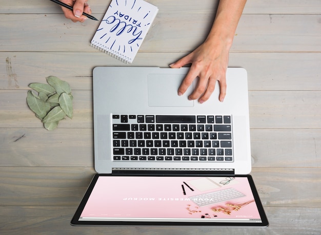 PSD laptop mockup with person typing on keyboard