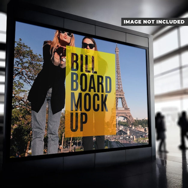 A large screen with a picture of a man and woman standing in front of a picture of the eiffel tower.