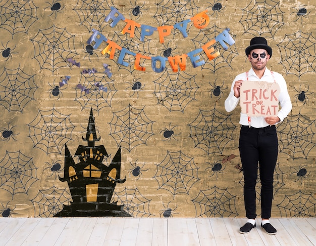 Long shot of man standing and wishing happy halloween