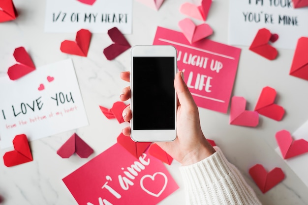 Love concept with hand holding smartphone