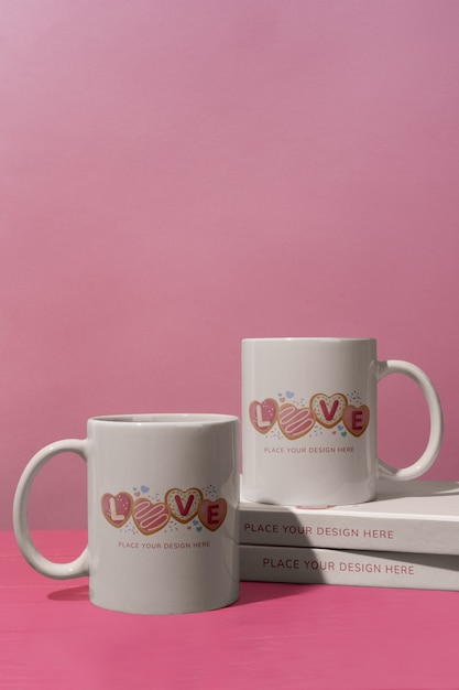 Love cups with books on pink background