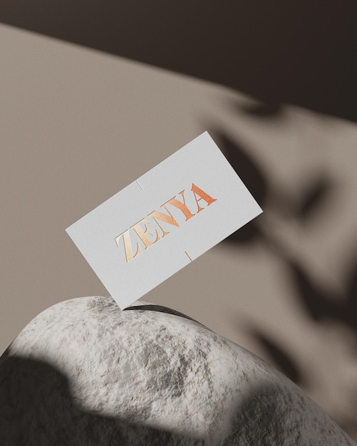 Luxury logo mockup on business card with shadow overlay with gold foil standing on a rock