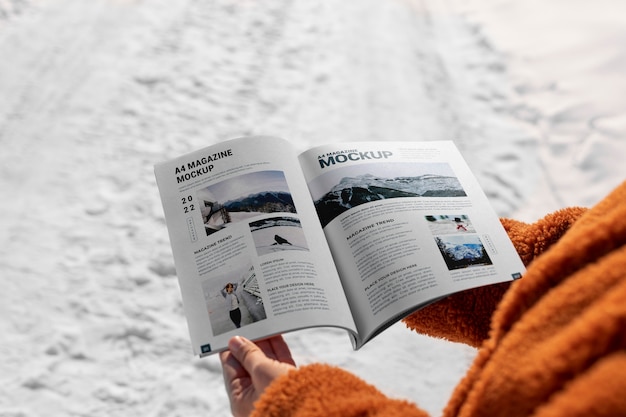 PSD magazine mockup held in hand