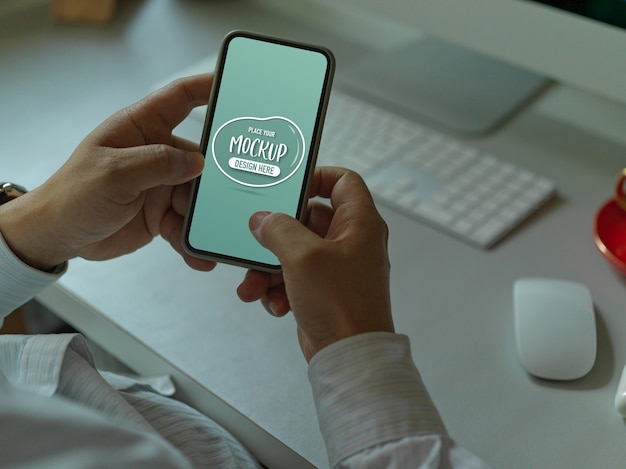 Male office worker texting on mockup smartphone