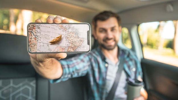 PSD man in car showing smartphone mockup