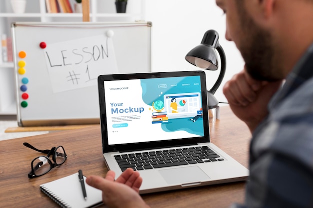 Man at desk with laptop mock-up