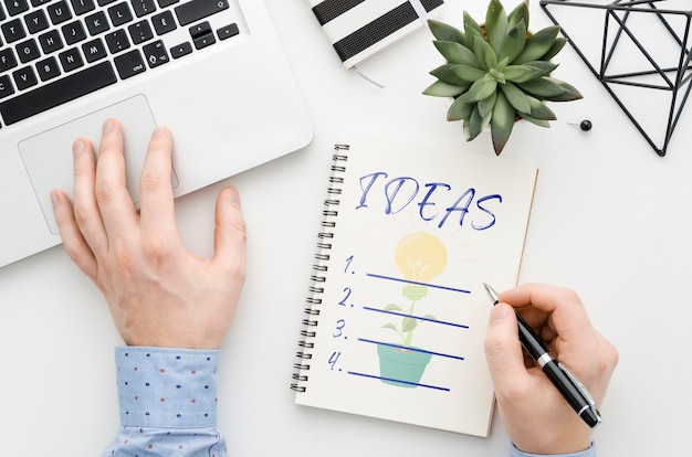 Man at desk writing on notebook mock-up