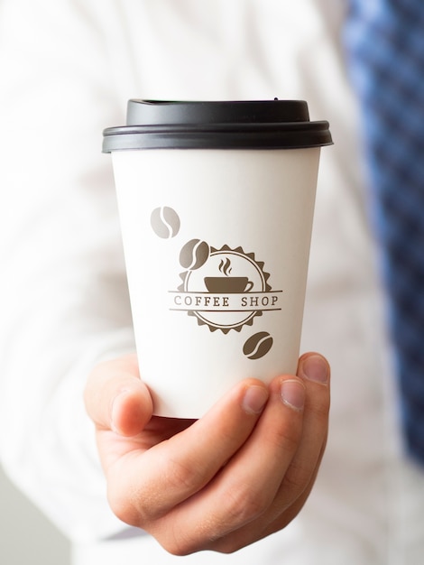 Man holding a cup of coffee close-up