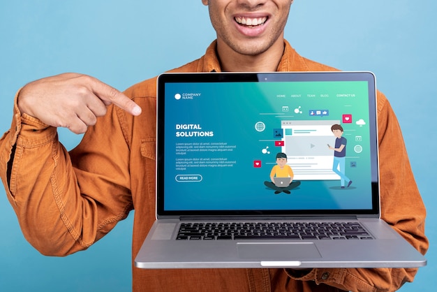 Man holding a laptop with a digital solution landing page