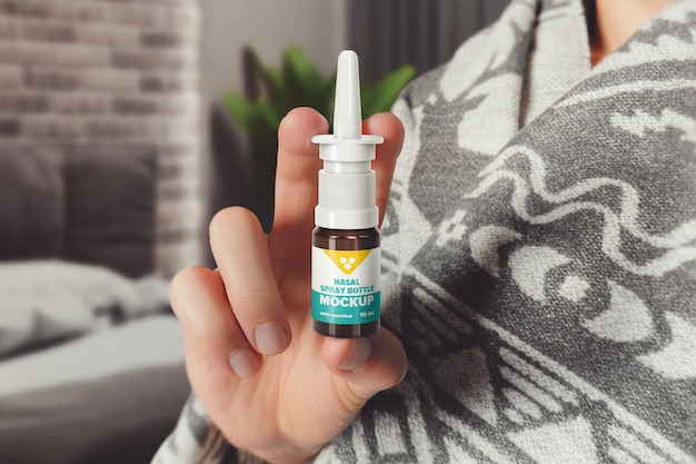 Man holding nasal spray bottle mockup