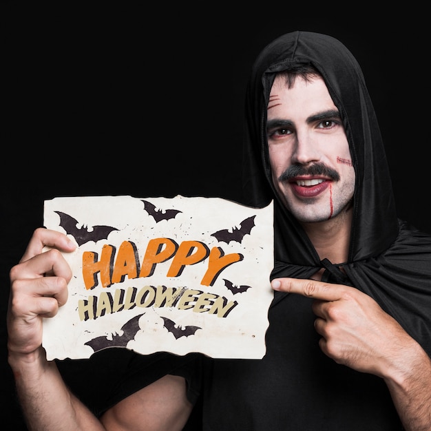 Man holding paper with halloween lettering