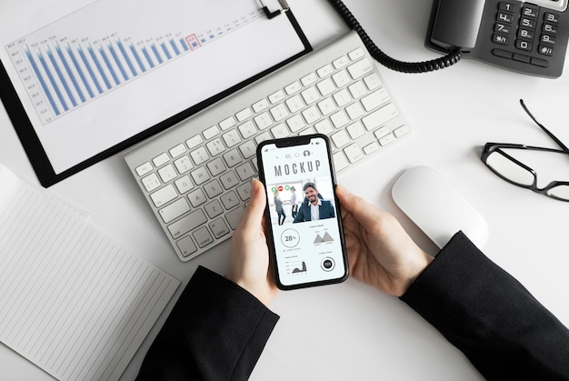 Man holding a smartphone mock-up at the office