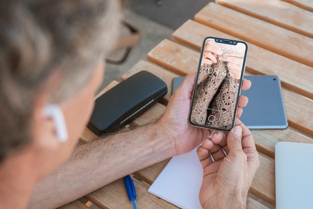 Man looking at smartphone mockup