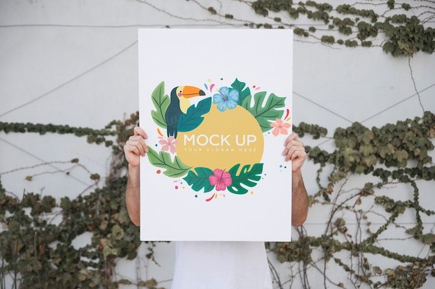 Man presenting poster mockup outdoors