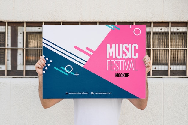 Man presenting poster mockup outdoors