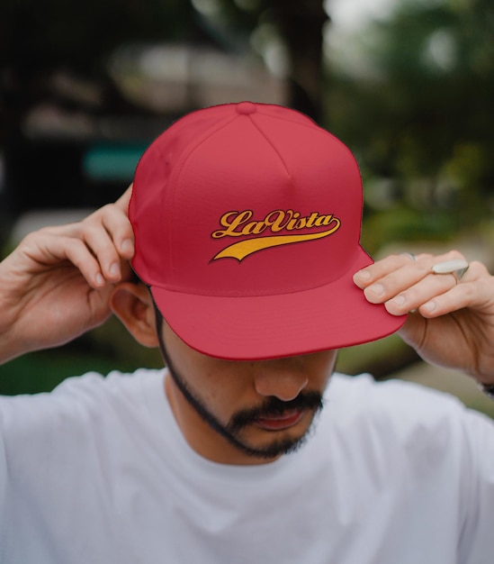 PSD a man wearing a red hat that says l'riura on it.